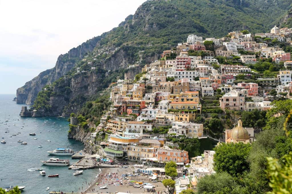 view of town of positano on hillside and sea