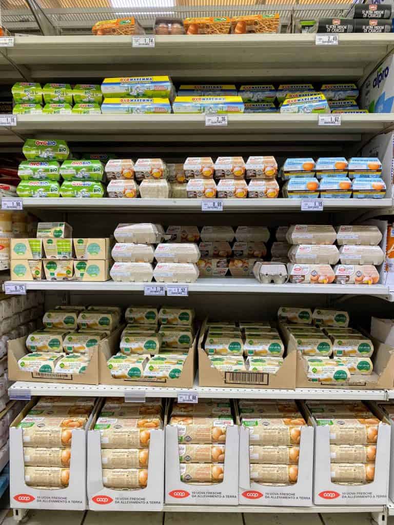 An aisle display of non-refrigerated eggs at an Italian grocery store.