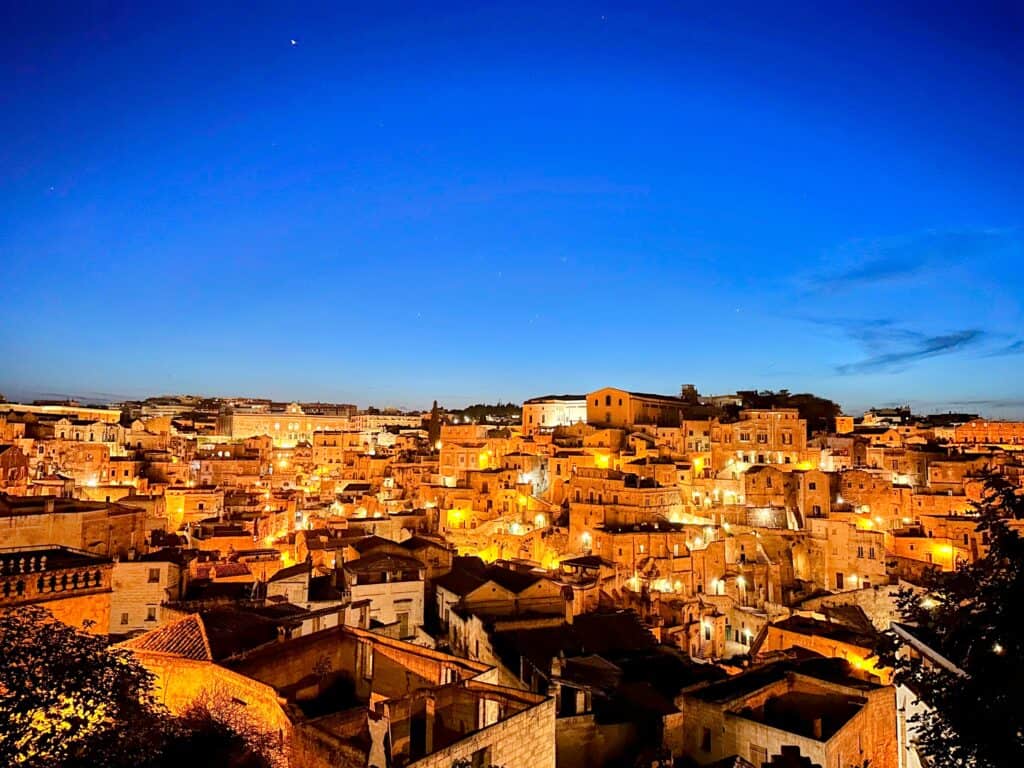 Matera, Italy's buildings lit up at night.