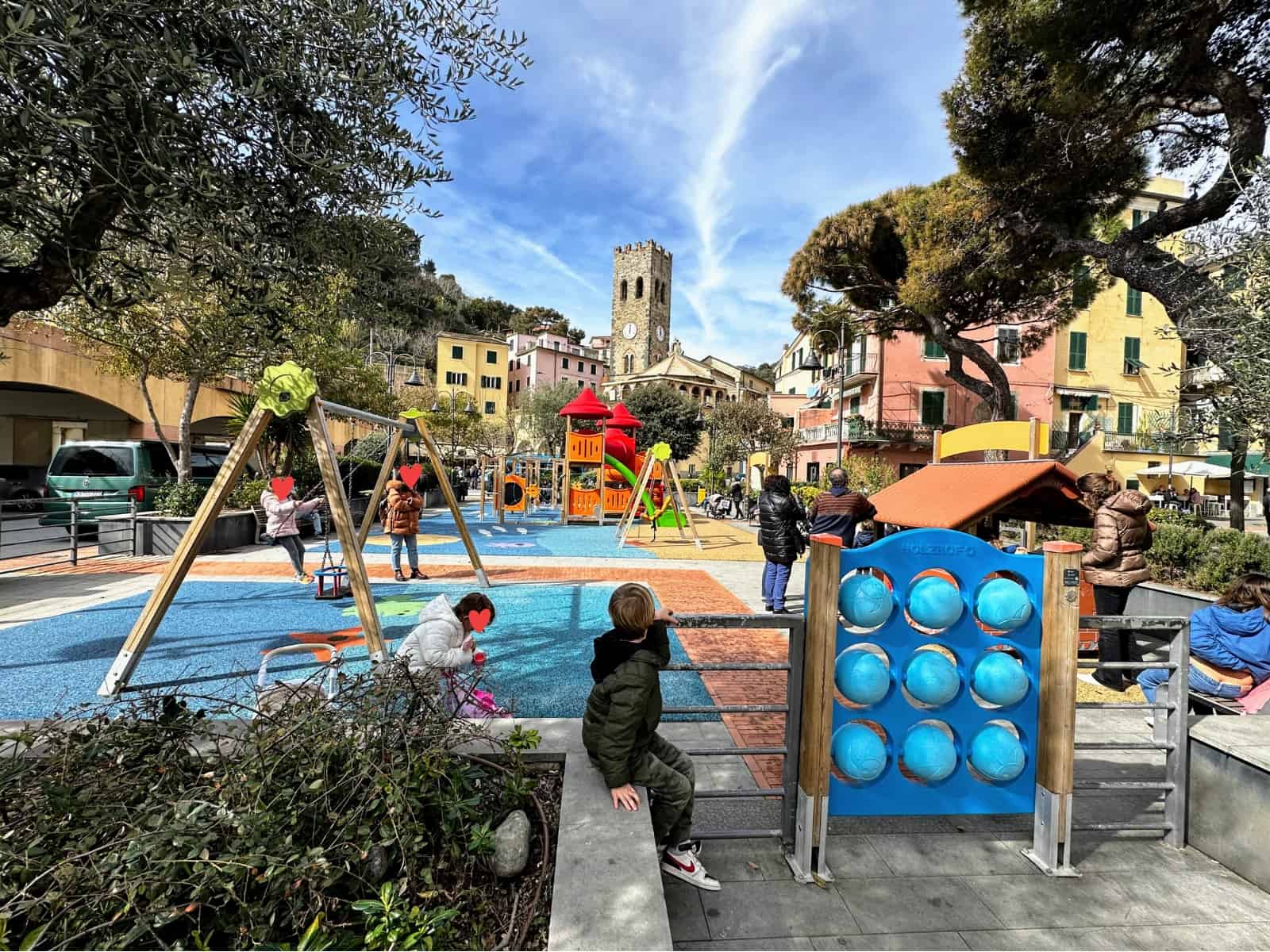 Boy at the edge of a colorful playground in Monterosso in the Cinque Terre, Italy.