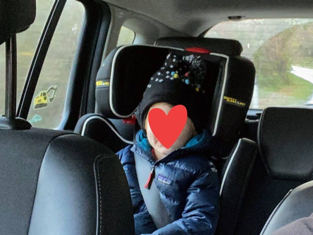 Boy in booster seat with back in Italy.
