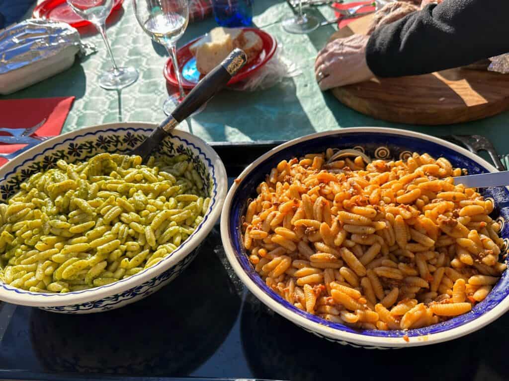 A Christmas table in Italy with two large bowls of pasta.