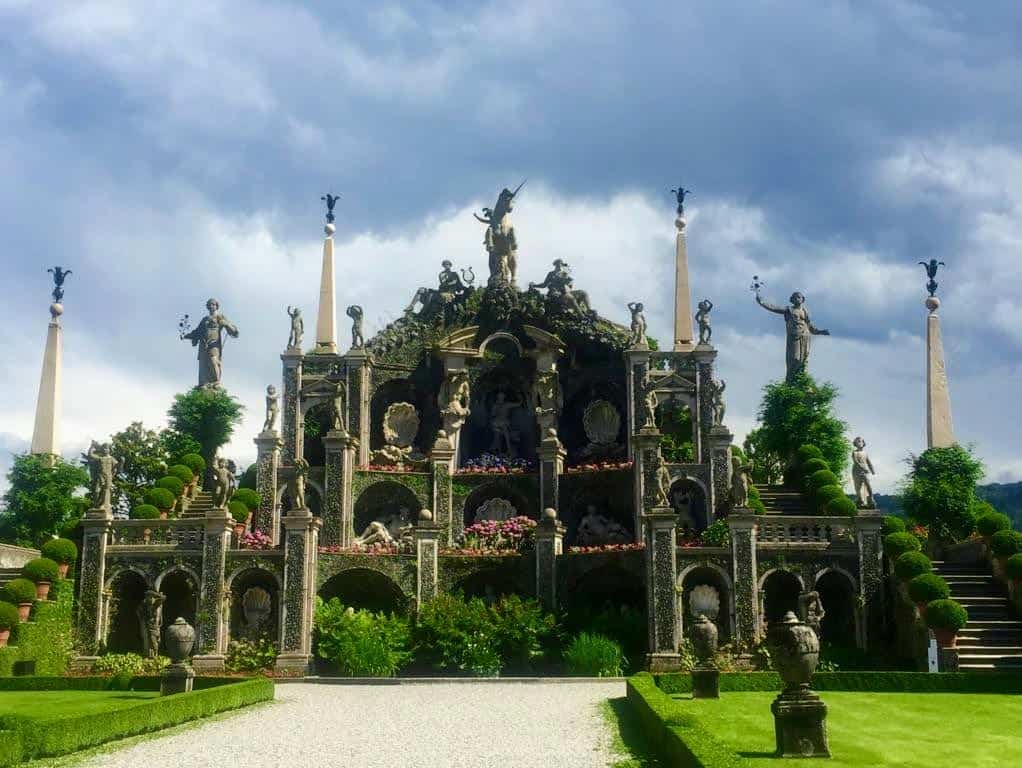 Isola Bella gardens in Stresa, Italy. Statues adorn a stone structure.