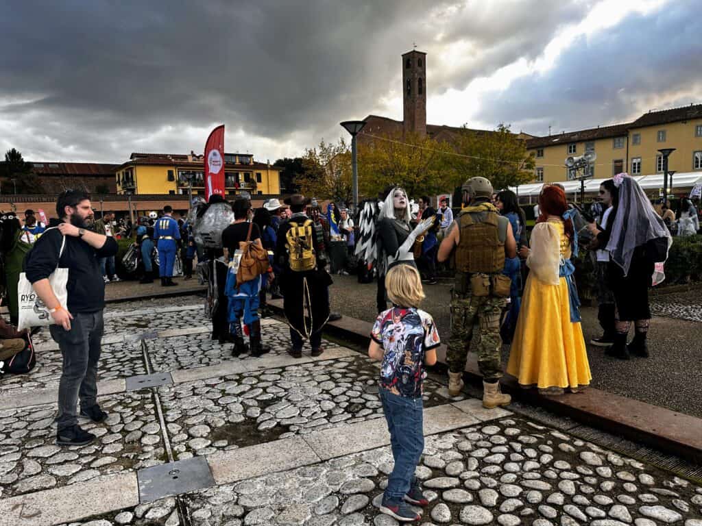 Boy and adults in costume on Halloween in the piazza in Lucca at Lucca Comics.