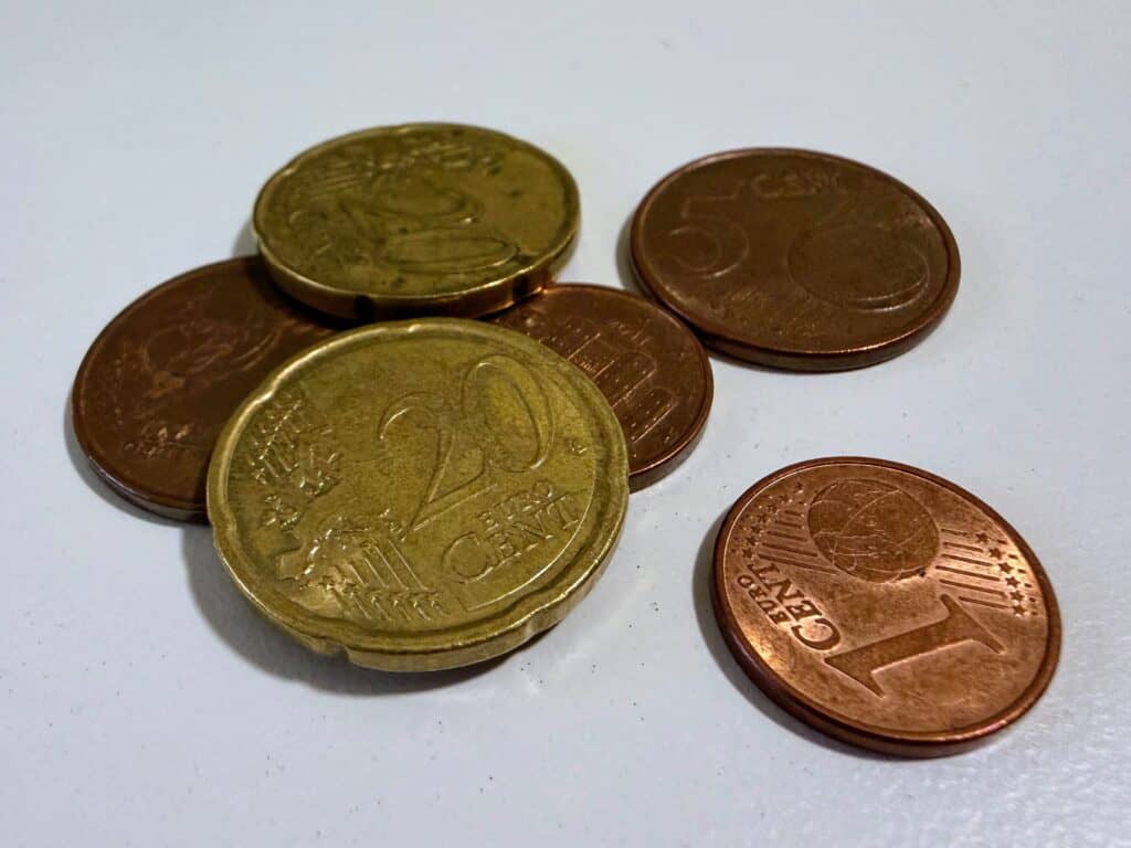 Small pile of Euro coins on a white surface.