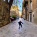 Boy jumping on street in Palermo, Italy.