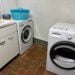 Laundry room in Italy with washer, dryer, and sink.